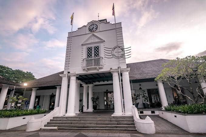 The Old Court House, Kuching — the white colonnaded frontage and clock tower at dusk.